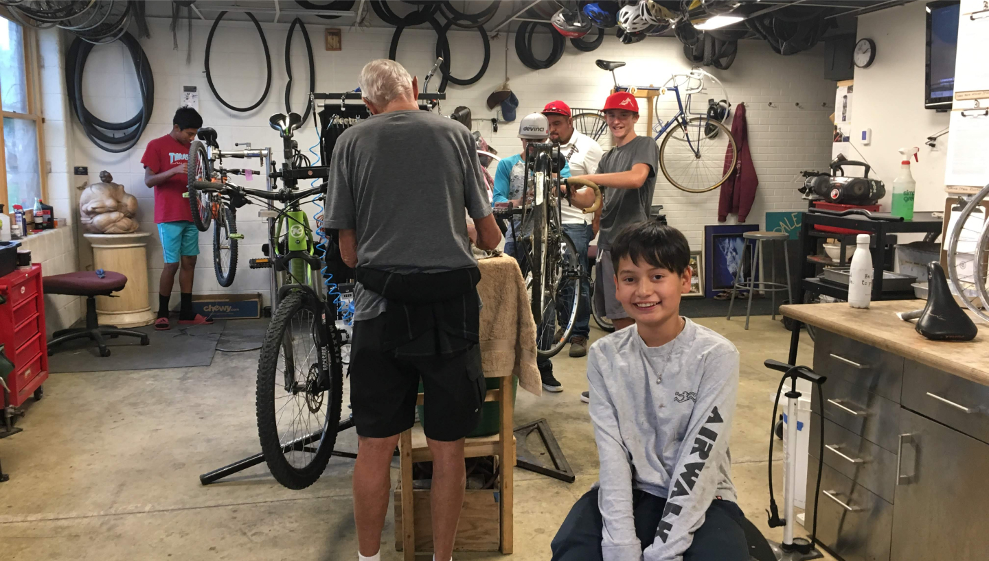 Young person working at the bike project